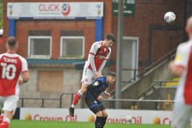 Fleetwood defender Morgan Boyes clears his lines at Rochdale