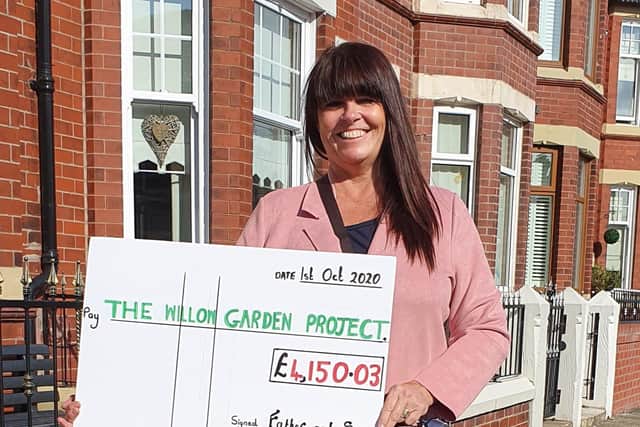 Pamela Laird, of the Willow Garden Project, with her cheque