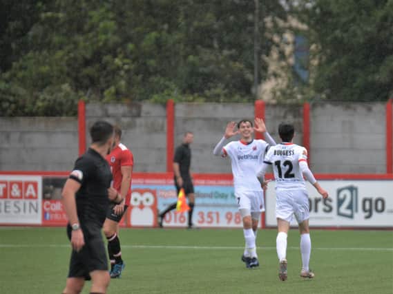Luke Burgess celebrates Fylde's fourth and final goal in the FA Cup win at Hyde United with fellow scorer Ben Tollitt  Picture: STEVE MCLELLAN