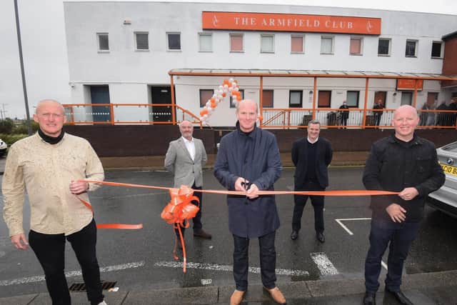 John Armfield, centre, officially opens the new supporters' bar while Blackpool FC representatives Brett Gerrity and Ben Mansford watch on