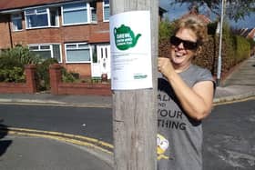 Sam Mcwhinnie is pictured putting up one of the posters for the coffee morning on Birch Way, Poulton