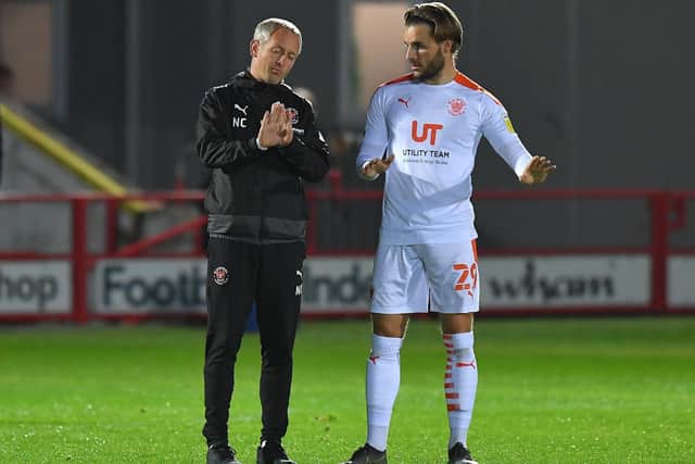 Luke Garbutt receives instructions from Blackpool boss Neil Critchley at Accrington this week