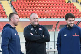 AFC Fylde boss Jim Bentley (centre) and backroom duo Nick Chadwick (left) and Andy Taylor can afford a smile as their side recorded their third win in a week at Gateshead  Picture: STEVE MCLELLAN