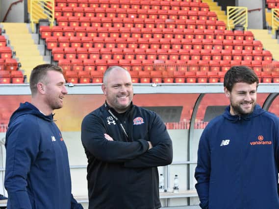 AFC Fylde boss Jim Bentley (centre) and backroom duo Nick Chadwick (left) and Andy Taylor can afford a smile as their side recorded their third win in a week at Gateshead  Picture: STEVE MCLELLAN