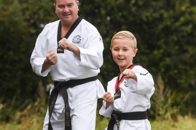 Taekwondo Master Lee Heyes with his protege, Cameron Boffey, who achieved his junior black belt in Taekwondo after attending classes and Zoom classes for four years.