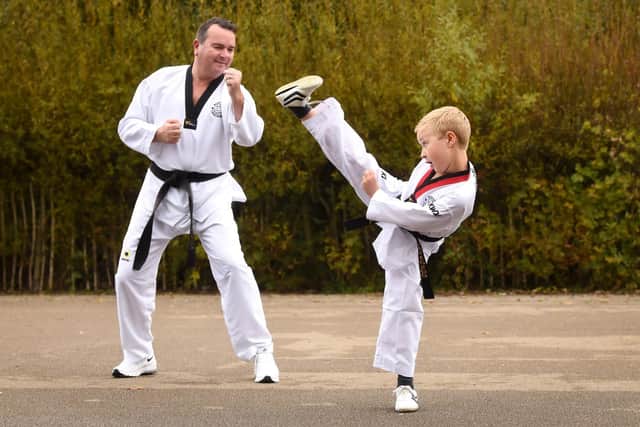 Taekwondo Master Lee Heyes from Northern Taekwondo Club, with Stanah primary school pupil Cameron Boffey.