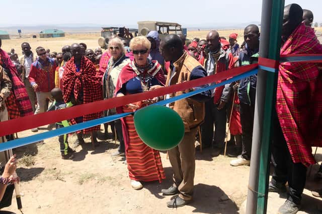 Paula Hammack cuts the ribbon at the opening of a new school