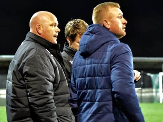 Jim Bentley (left) and his management team watch AFC Fylde make it four wins out of four in all competitions this season at Farsley Celtic Picture: STEVE MCLELLAN