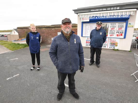 The Friends of Fleetwood Yacht Lake Convenience Group are fundraising to get the public toilets reopened. Pictured is Amber Blyth from Dolly's with chairman William Hargreaves and coun Brian Crawford.