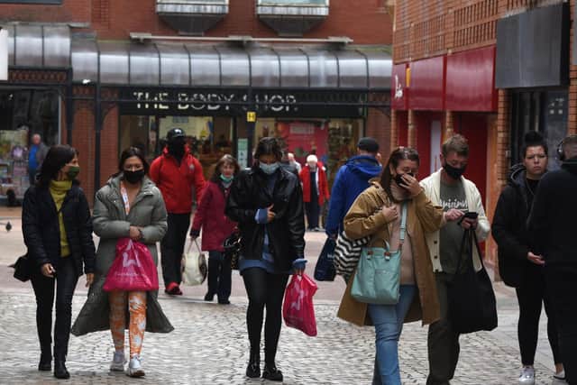 Glum-looking shoppers in masks go about their business in Corporation Street, Blackpool town centre, on Saturday (Picture: Neil Cross for The Gazette)