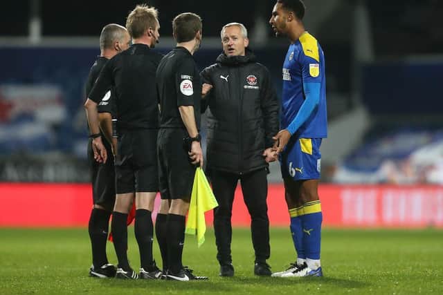 Neil Critchley speaks to the officials after the full-time whistle