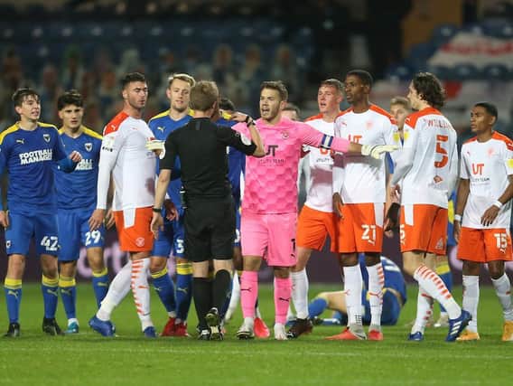 Blackpool's players remonstrate against Ethan Robson's sending off