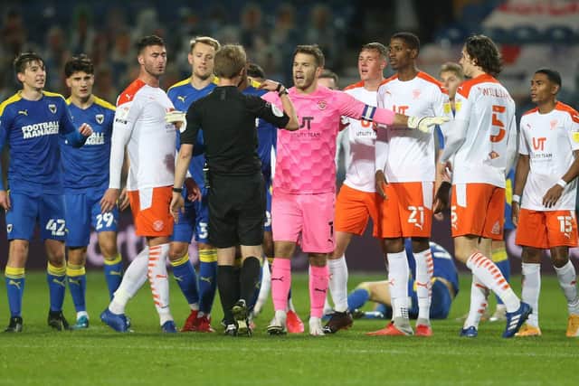 Chris Maxwell protests over Ethan Robson's red card against Wimbledon