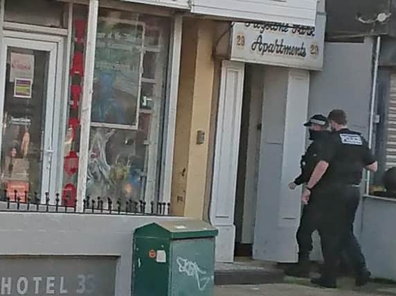Officers enter the premises on Dickson Road