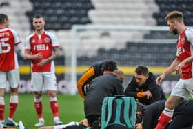 Ched Evans is treated on the pitch in the opening moments of Fleetwood Town's FA Cup tie at Hull