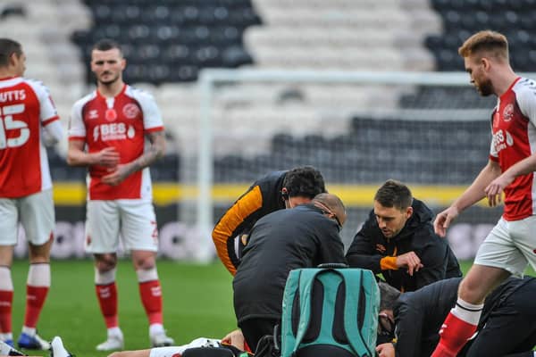 Ched Evans is treated on the pitch in the opening moments of Fleetwood Town's FA Cup tie at Hull