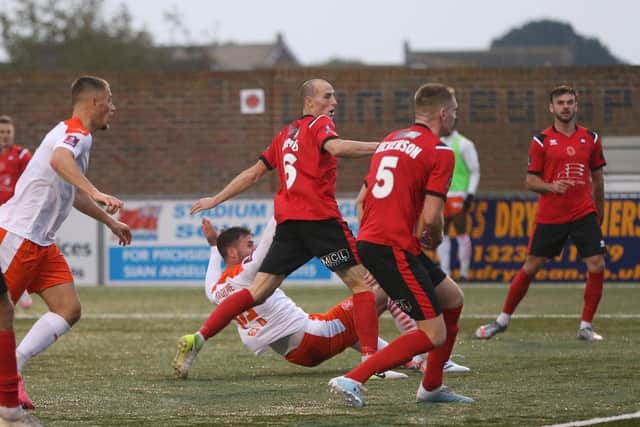 Gary Madine scores the first of his two goals at Eastbourne