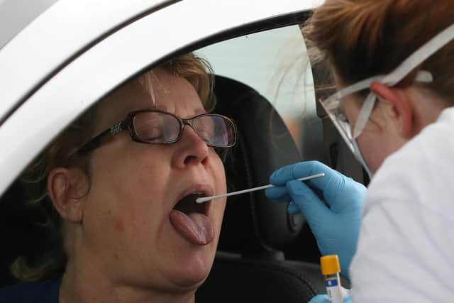 A file image, dated April 29, 2020, of a test sample being taken at a Covid-19 testing centre. A rapid test that can detect coronavirus within minutes will be a "life-changer", an expert said earlier this year (Picture: PA Wire/PA Images)