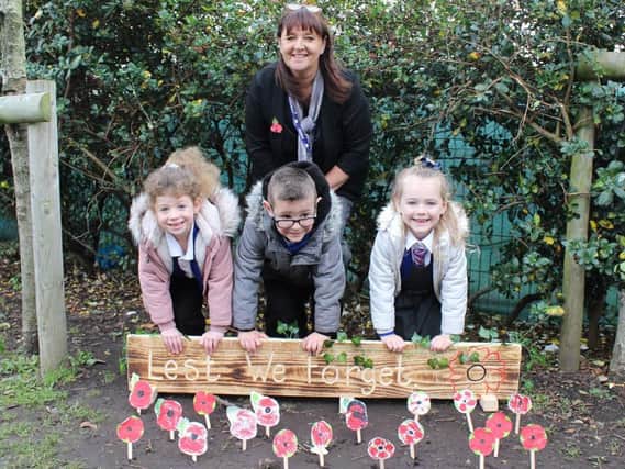 Gateway headteacher Sue Robinson with reception class pupils and their hand made poppies