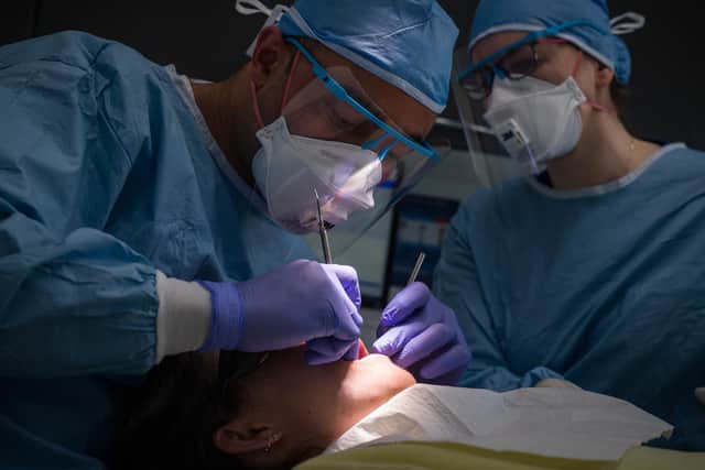A file image of two dentists carrying out a procedure on a patient during the pandemic (Picture: Leon Neal/Getty)