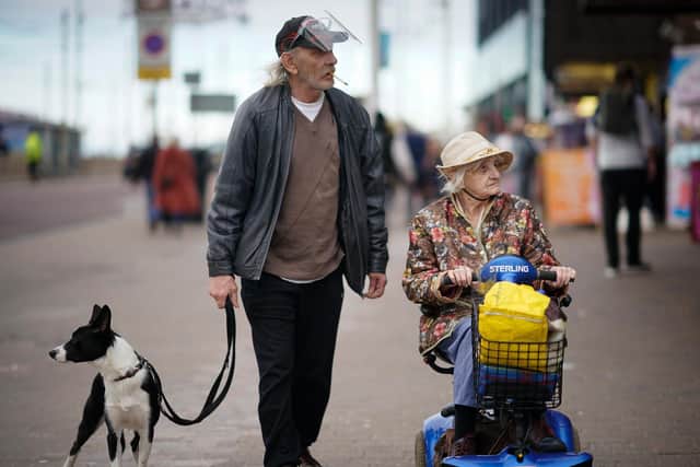 A man wears a safety visor against Covid-19 on the promenade on October 16, 2020 in Blackpool (Photo by Christopher Furlong/Getty Images)