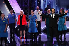 Members of the choir on  the Royal Variety stage with singer Michael Ball
