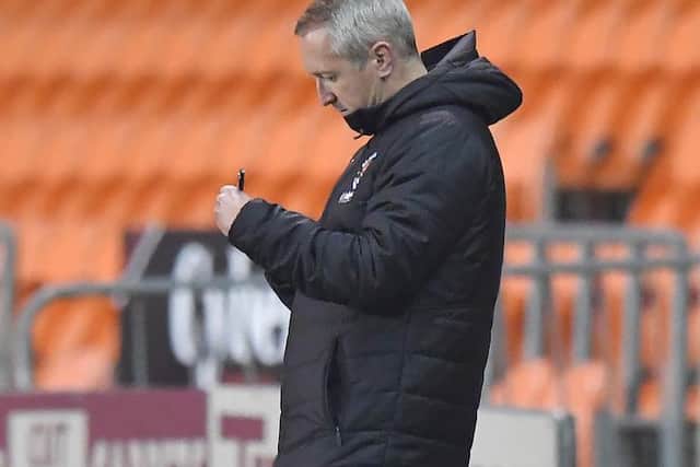 Neil Critchley scribbles down some notes during Blackpool's victory against Portsmouth last night
