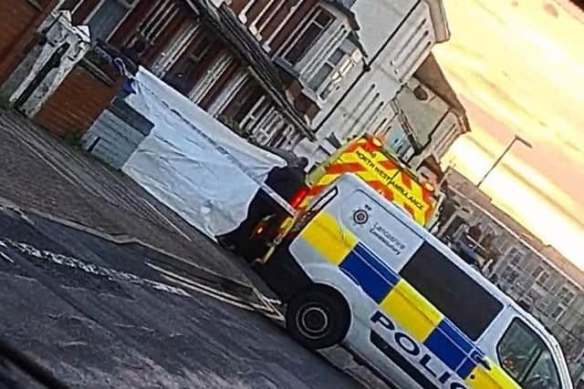 The scene on Cross Street after the body of a man was found