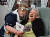Louise Newton, left, with Ann Trowbridge and a Christmas card at the Brookside Care Home on December 1, 2020 (Picture: Neil Cross for JPIMedia)