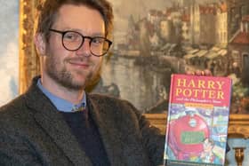 Hansons’ books expert Jim Spencer with the first edition. The Rumsey family, from Preston, found a long lost first edition of a Harry Potter book and were going to send it to a car boot sale before they realised it could be valuable. The first edition of Harry Potter and the Philosopher's Stone is set to be auctioned in December 2020 and could fetch £50,000. Picture courtesy Mark Laban/Hansons Auctioneers