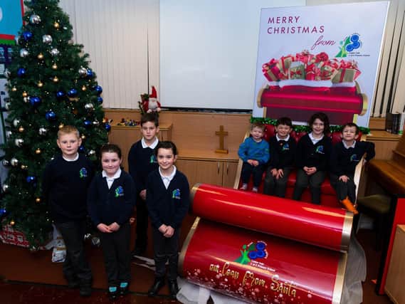 Photo shows (from left) Tom, Lily, Alex, Evie, Alexis, Joe, Cara and Hector from Calder Vale school with the donated Christmas decorations and sleigh. 
Photo: Kelvin Stuttard