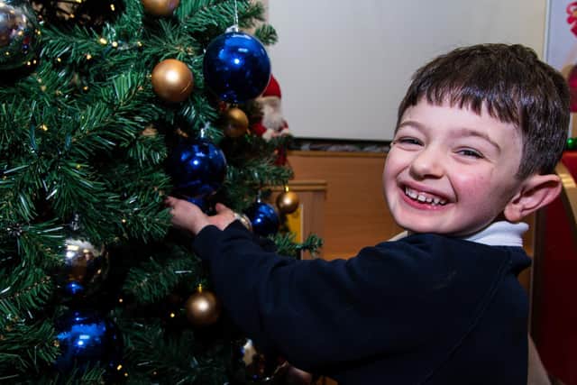 Joe from Year One  at Calder Vale school admires the special  Christmas decorations Photo: Kelvin Stuttard