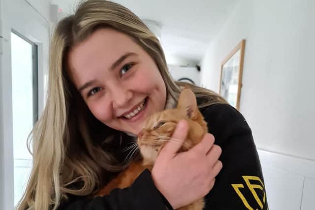 Furry Tails volunteer Rhia Taylor with cat rescued from house fire