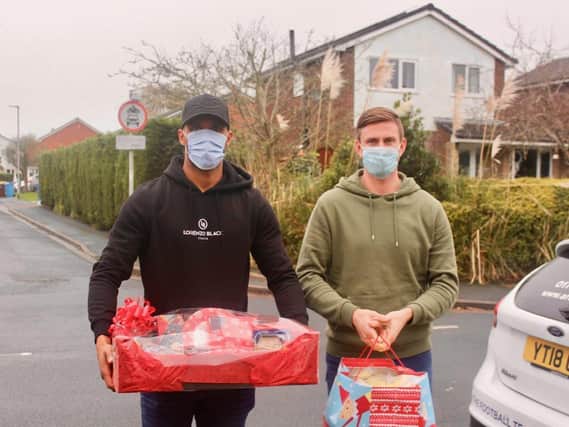 The fitness of Chris Neal (right) and Nathan Pond, here delivering Christmas presents in the community this week, is a boost for AFC Fylde going into the festive fixtures
