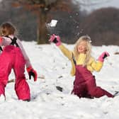 Ruby Millington (left) and Molly Chamberlain play in the snow at Tatton Park, Knutsford