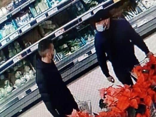 Police want to identify these two men after a purse was taken from a 75-year-old woman in Kikrham Morrisons on Monday, December 21. Pic: Lancashire Police