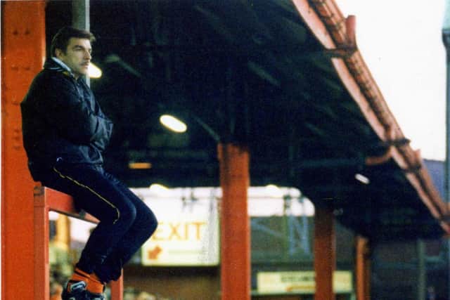 Sam Allardyce sitting atop of the Bloomfield Road dugout