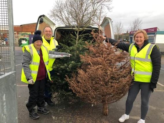 Volunteers Howard and Elaine Midgley with Helen Roe from Trinity’s Fundraising Team during last year’s Christmas tree collection