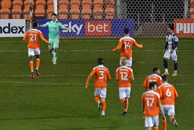 Blackpool's players run to celebrate with penalty hero Chris Maxwell