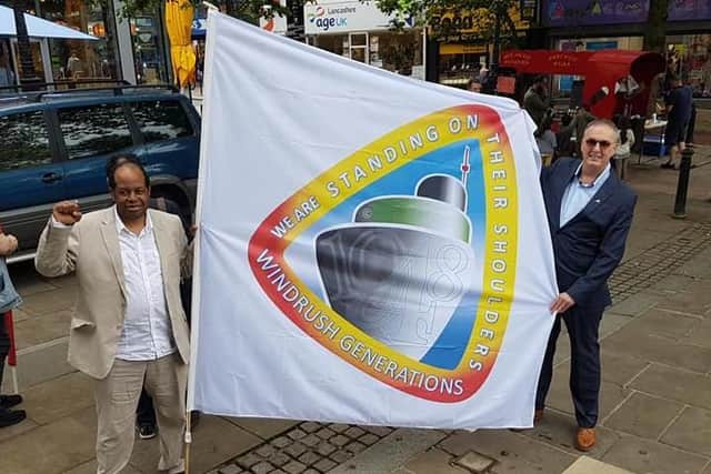 Anthony Brown, Chair of Preston Windrush Generation and Descendants UK and co-founder of the Windrush Defenders Legal CIC (community interest company) and Lancashire's Police and Crime Commissioner Clive Grunshaw  pictured with banner highlighting the ongoing work  to raise awareness of the Windrush community
