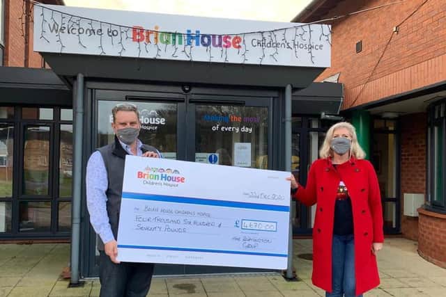 Andrea Challis and Robert Kearsley joint chief executives of Partington’s, making their donation to Brian House Children's Hospice