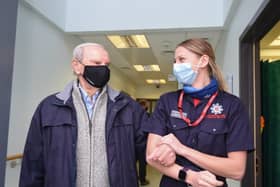 Geoffrey Mitchell is walked out of Lytham Primary Care Centre by Lancashire Fire and Rescue Service community safety officer Robyn Morris after having a Covid-19 vaccine on Wednesday, January 13, 2021 (Picture: Daniel Martino for JPIMedia)