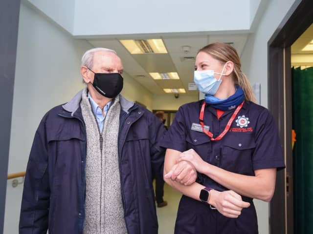Geoffrey Mitchell is walked out of Lytham Primary Care Centre by Lancashire Fire and Rescue Service community safety officer Robyn Morris after having a Covid-19 vaccine on Wednesday, January 13, 2021 (Picture: Daniel Martino for JPIMedia)