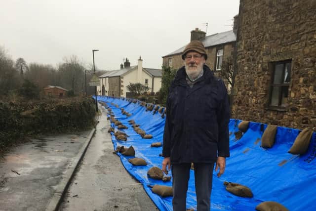 Mr Brian Woodward pictured by the flood defences installed on Greenside, Ribchester