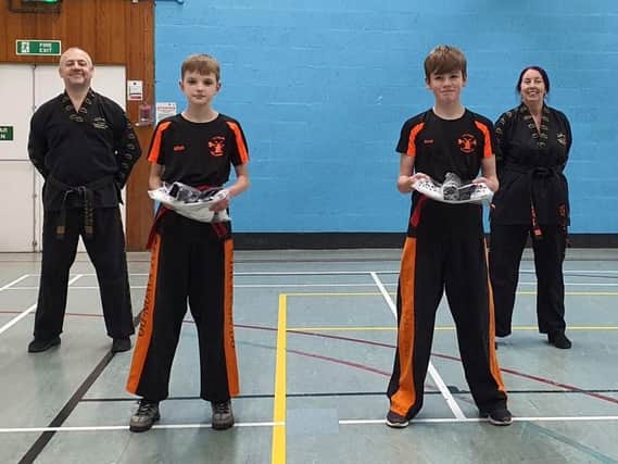 Successful Lytham Tae Kwon-Do pupils Max Wilson (left) and Scott Ingleby with instructors (back) Bob and Dianne Russell.