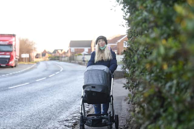 Pictured is Linda Gallagher demonstrating the narrow pavement.