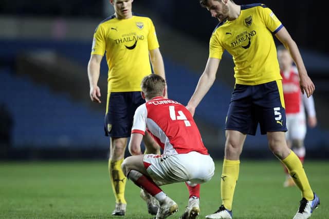 Fleetwood's Callum Connolly is consoled by Elliott Moore after Town's defeat at Oxford