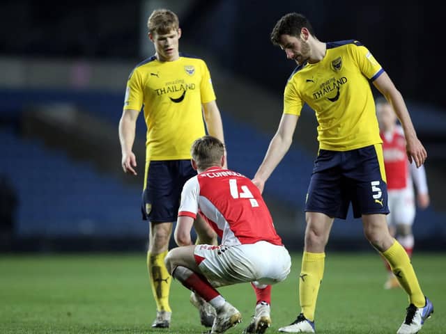 Fleetwood's Callum Connolly is consoled by Elliott Moore after Town's defeat at Oxford