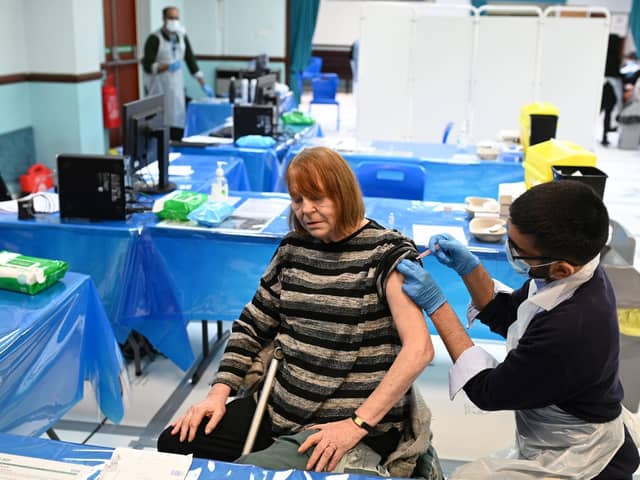 Pharmacist, Minhal Master administers a dose of the AstraZeneca/Oxford Covid-19 vaccine at a temporary vaccination centre