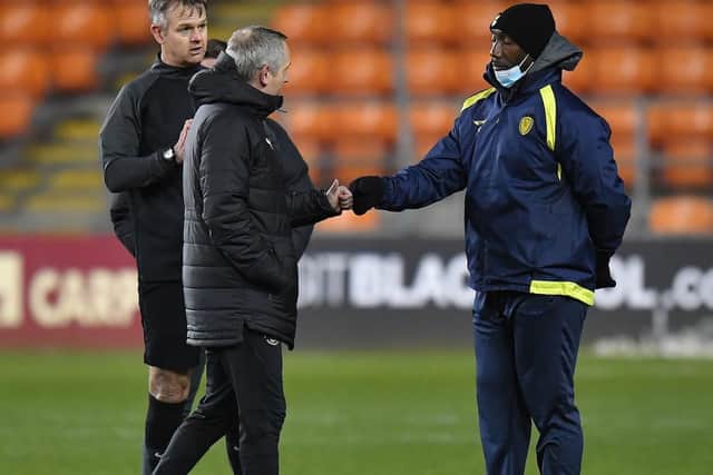 Jimmy Floyd Hasselbaink with referee Christopher Sarginson and Blackpool boss Neil Critchley
